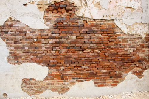 Fototapeta Kruszenie tynku na ścianie z cegły